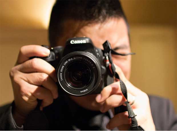 man focusing a camera