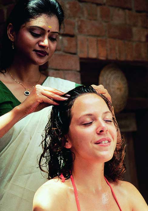 Woman getting a head massage with thyme oil