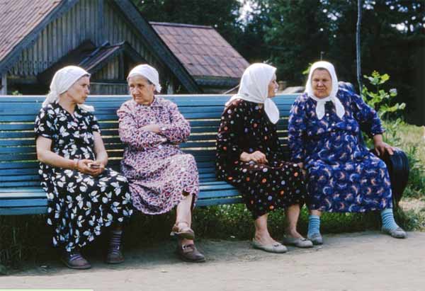 Four older women sitting on a bench
