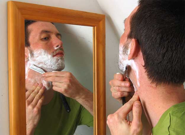 man shaving his beard