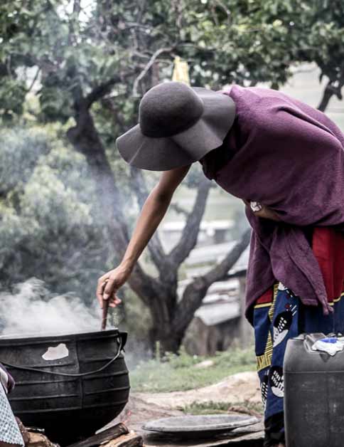 Woman stirs a big pot